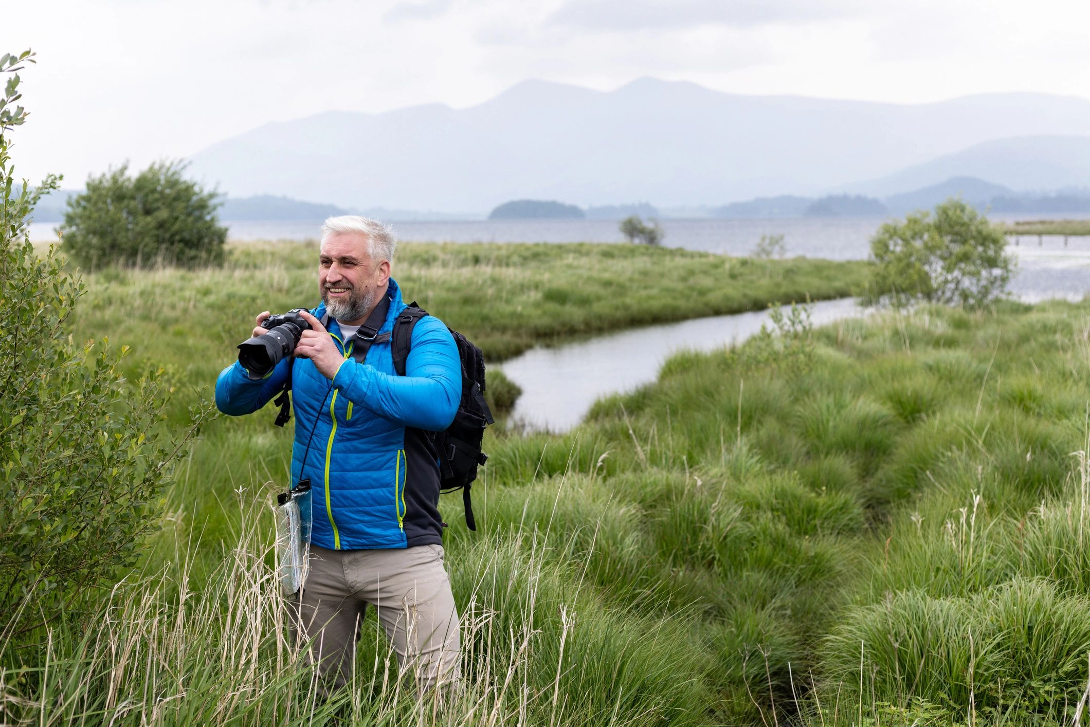 Photographer outdoors capturing nature in a peaceful landscape