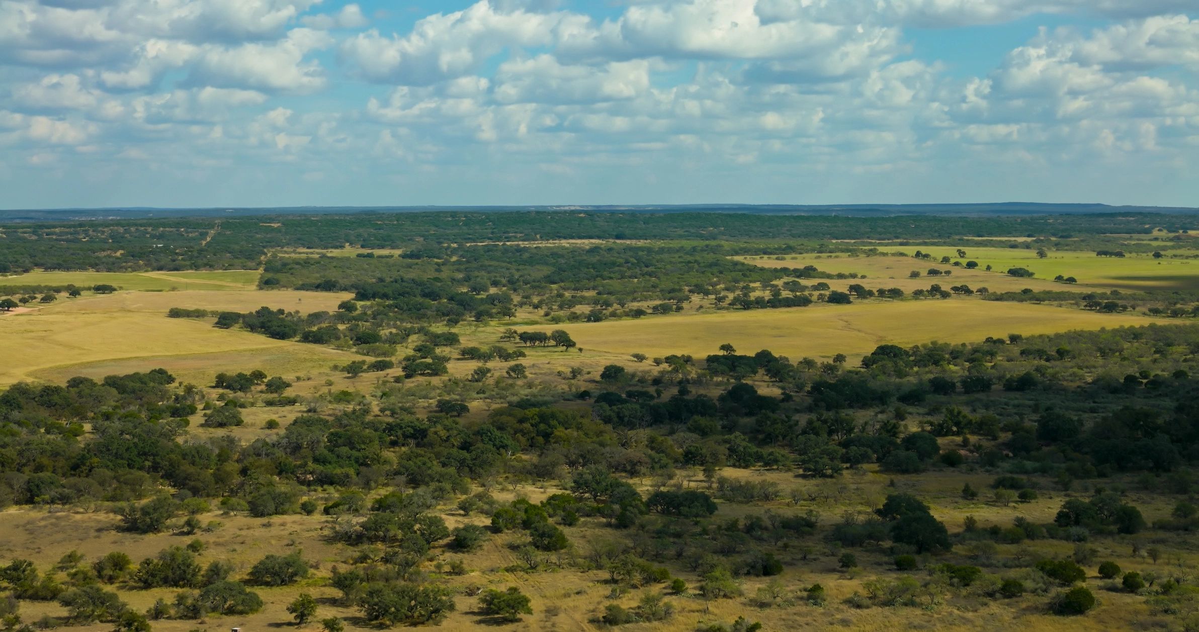 Aerial view of rolling hills and farmland